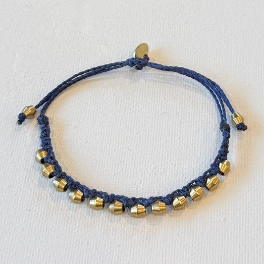 navy adjustable waxed nylon interlocking brass shapes. One size fits all. This bracelet has a nice weight to it.